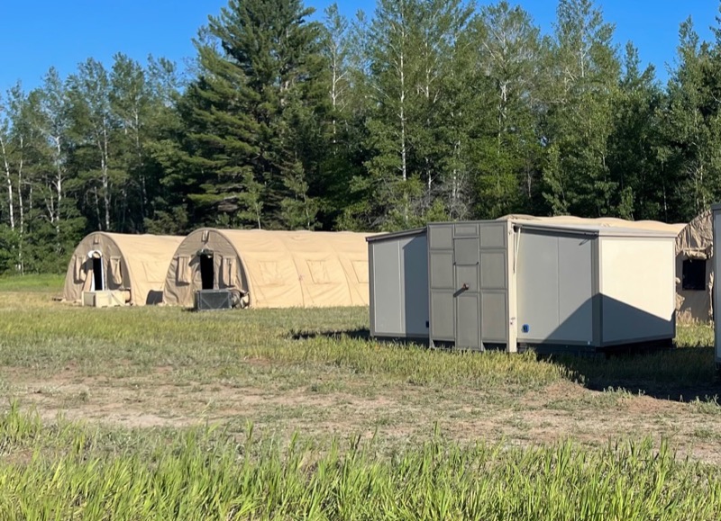 ACE shelter with a tent in the background